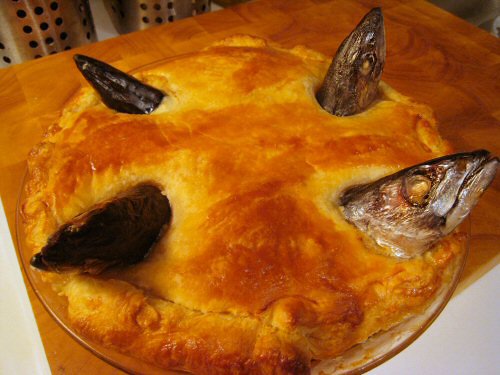Stargazy pies and carols. "Baked stargazy pie" by Krista. Uploaded by Diádoco. Licensed under CC BY 2.0 via Commons.